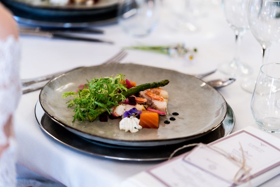 A gourmet dish with vegetables and sauce elegantly presented.